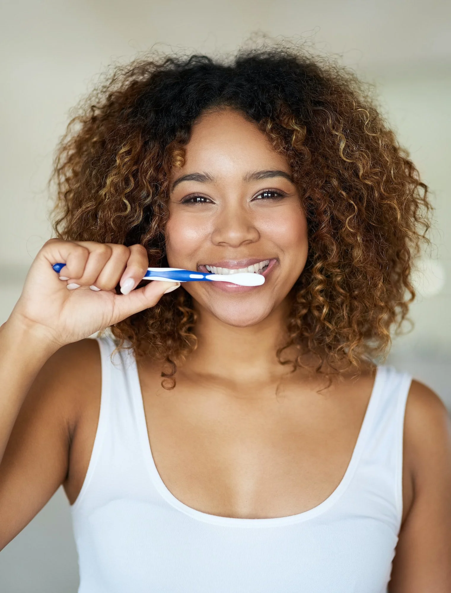 Look after that beautiful smile of yours. Shot of a young woman brushing her teeth in her bathroom.